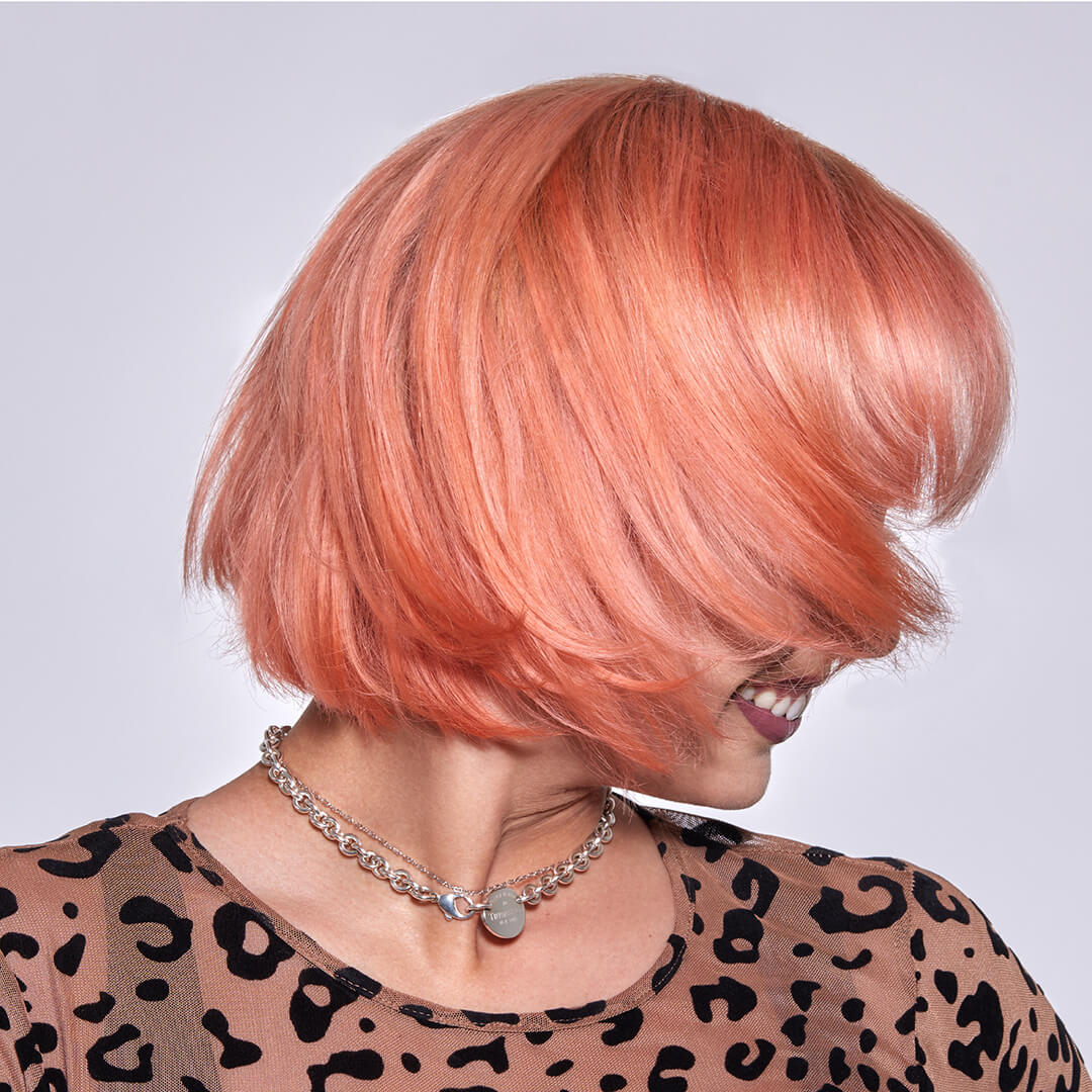 A photo of a model wearing Splat Peachy Coral Hair Dye