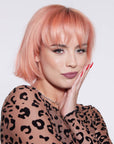 A photo of a model wearing Splat Hair Color's Peachy Coral Hair Dye